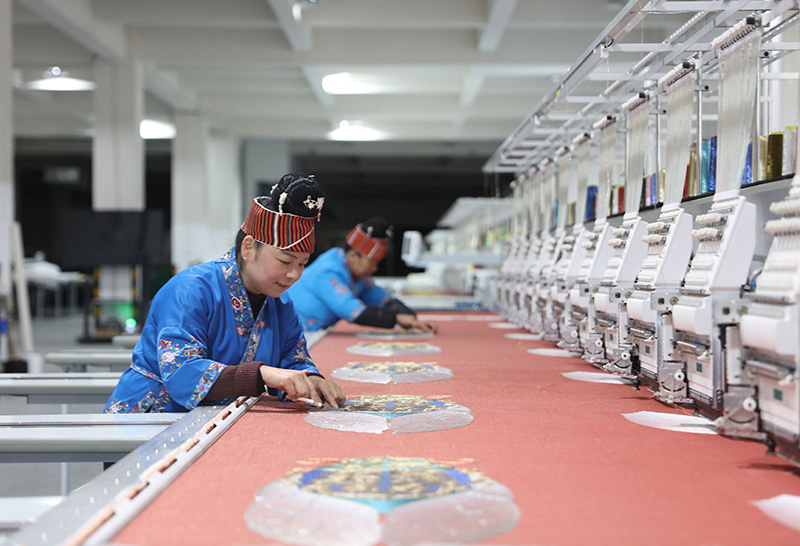 2023年2月13日，贵州省黔东南苗族侗族自治州施秉县工业园区，工人在机绣车间作业。